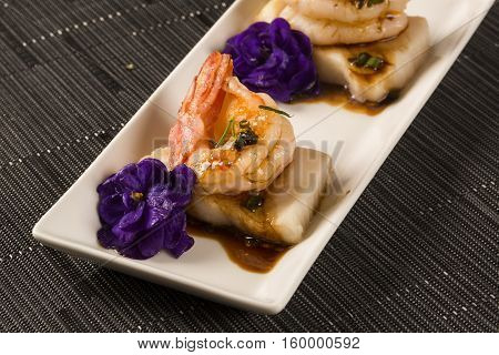 Grilled Shrimp With Raw Nail Fish On White Plate At Table