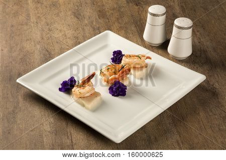 Grilled Shrimp With Raw Nail Fish On White Plate At Table