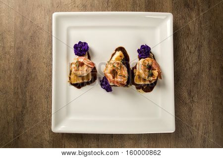 Grilled Shrimp With Raw Nail Fish On White Plate At Table