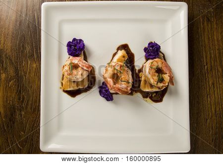 Grilled Shrimp With Raw Nail Fish On White Plate At Table