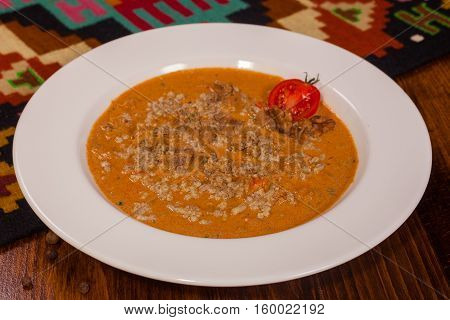 Georgian Cuisine. Soup With Walnuts In A White Plate
