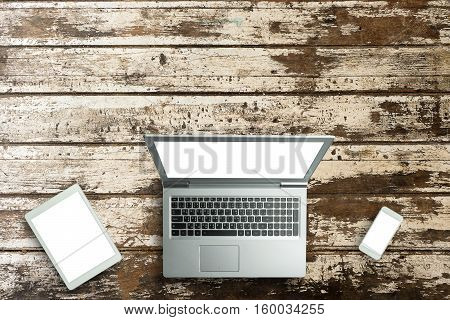 Top View Of Digital Laptop Computor, Tablet And Smartphone White Screen On Wooden Table Background.c