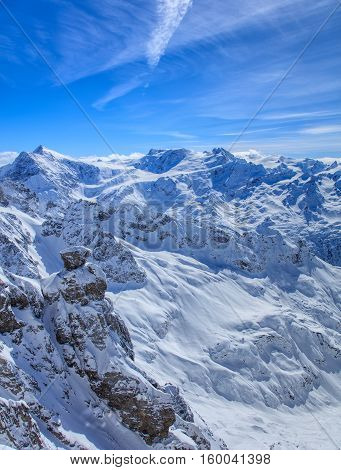 Alps, view from the top of Mt. Titlis in Switzerland. Mount Titlis is a mountain located on the border between the Swiss Cantons of Obwalden and Bern, mainly accessed from the town of Engelberg.