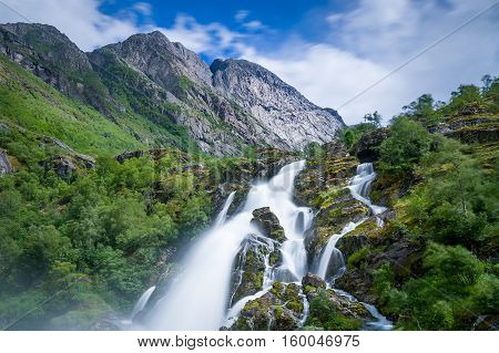 Briksdalsbreen waterfall long exposure and close view photo. Norway national park and popular hiking path.