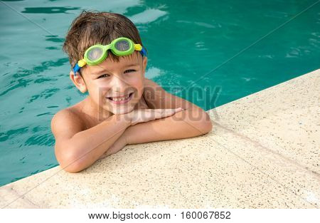 Pretty little boyl in swimming pool