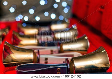 Set of gold handbells in red box with bokeh defocused blurred. Christmas time