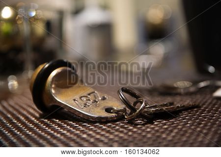 Old hotel room key from brass with the number 237 blurred background with copy space
