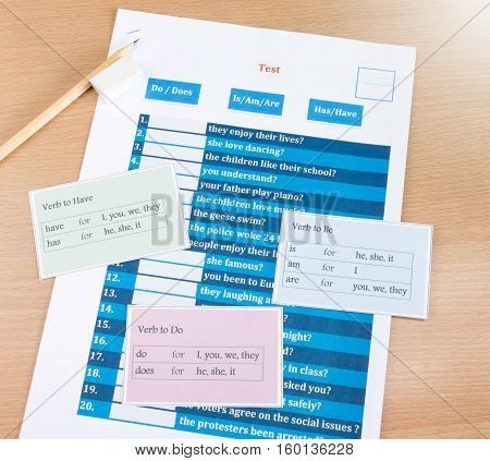 blue english verb test with cards on table