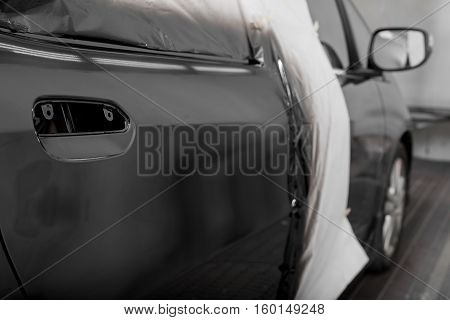 Auto body repair series : Black car after repaint in paint booth
