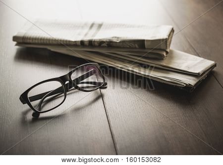 Newspaper And Reading Glasses On Business Desk Business Newspaper Background Concept.