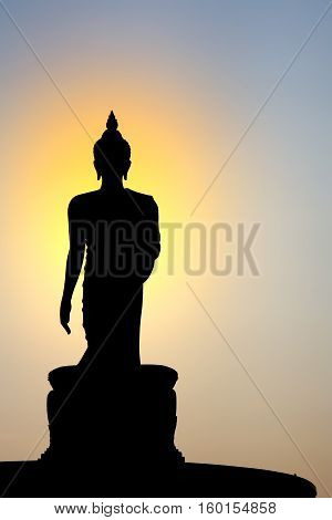 silhouette buddha statue sacred with sunset on blue sky at phutthamonthon in Thailand