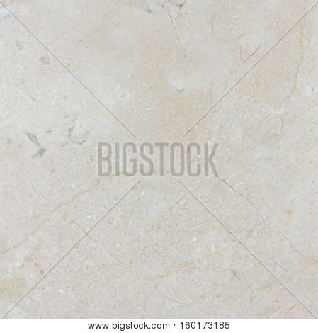 Natural beige polished Spanish Crema Marfil marble texture.