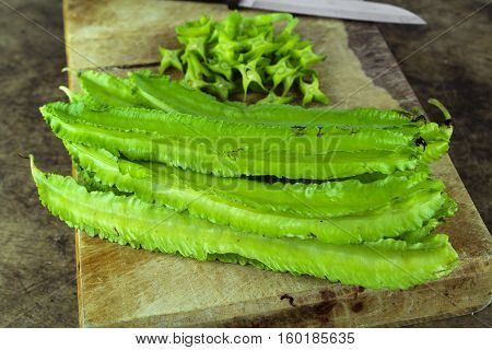 Winged beans on wooden background, Princess bean, Goa bean