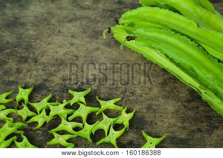Winged beans on wooden background, Princess bean, Goa bean