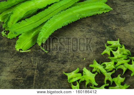 Winged beans on wooden background, Princess bean, Goa bean