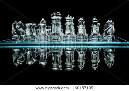 Detail shot of chess set with glass pieces with reflection.