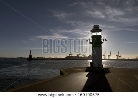 AARHUS DENMARK - NOVEMBER 24 2016: Portside lighthouse in the port of Aarhus. Container Port is the largest in Denmark seen in the background November 24 2016