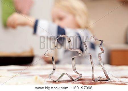 christmas activity for children little boy baking in a kitchen focus on pastry cutter