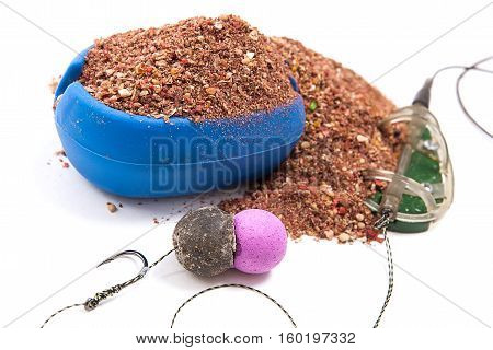 Dry Feed For Carp Fishing. Ready For Use Carp Bait With Fishing Flat Feeder For Carp Fishing Isolate