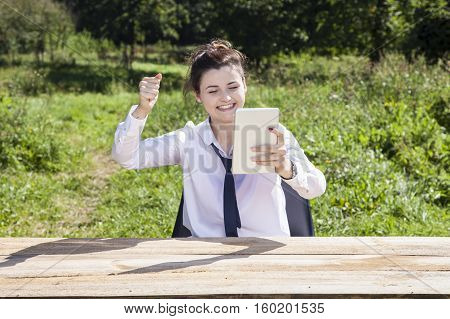 Happy Business Woman Raises Her Hand In A Gesture Of Success
