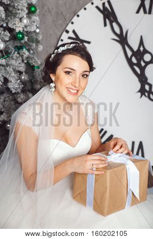 Hands with gift box on the wedding celebration. Studio portraits of beautiful bride with gift .Bride Holding Gift
