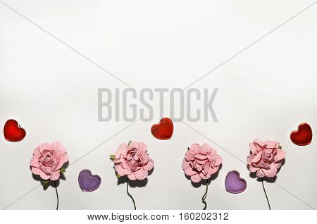 beautiful card for the holiday of love. Background for Valentine's Day. Postcard for weddings. Pink flowers on a white background scattered small hearts.