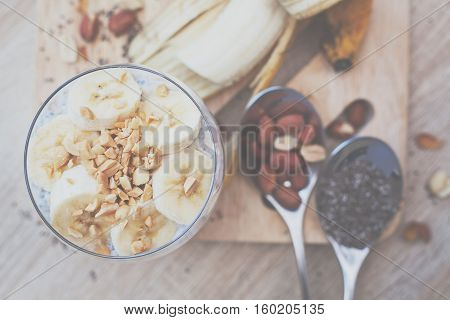 Banana chia yogurt pudding decorated with ripe sliced banana and peanuts