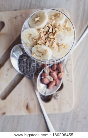 Banana chia yogurt pudding decorated with ripe sliced banana and peanuts