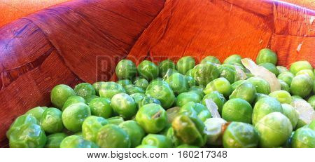green peas in the brown bowll ready to eat