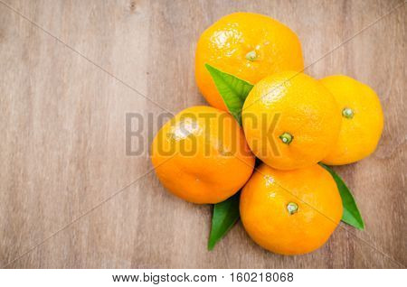 Fresh Organic Tangerines on a Wooden Background. Delicious and Beautiful Tangerines. Selective Focus. Top View