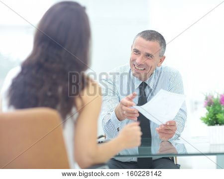 boss discusses with the assistant business documents in the offi