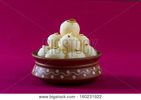 Indian Sweet or Dessert - Rasgulla, Famous Bengali sweet in clay bowl