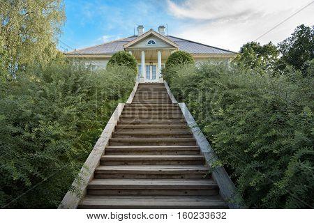 Pushkin Mountains, stairs leading to the house of the poet on the background of blue sky