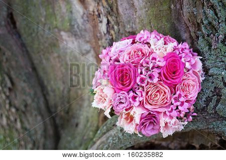 Pink wedding bouquet on a tree different shades of pink