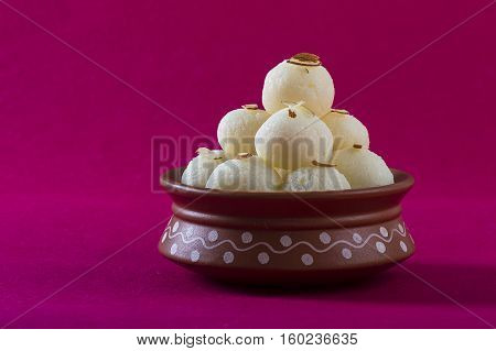 Indian Sweet or Dessert - Rasgulla, Famous Bengali sweet in clay bowl