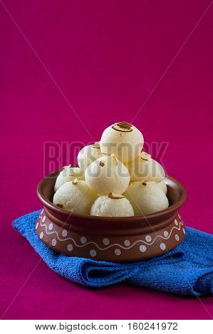 Indian Sweet or Dessert - Rasgulla, Famous Bengali sweet in clay bowl with napkin