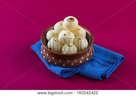Indian Sweet or Dessert - Rasgulla, Famous Bengali sweet in clay bowl with napkin