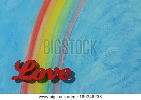 The word love with a background rainbow illustrating the concept of love lust desire and joy; in landscape format