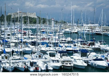 ANTIBES FRANCE - JULY 2 2007: Yachts in the port under Fort Carre. Antibes is a Mediterranean resort in the Alpes-Maritimes department of southeastern France on the Cote d'Azur between Cannes and Nice.