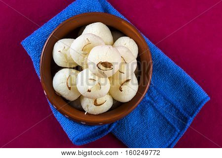 Indian Sweet or Dessert - Rasgulla, Famous Bengali sweet in clay bowl with napkin