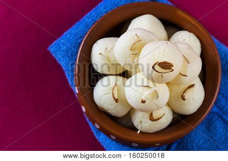 Indian Sweet or Dessert - Rasgulla, Famous Bengali sweet in clay bowl with napkin