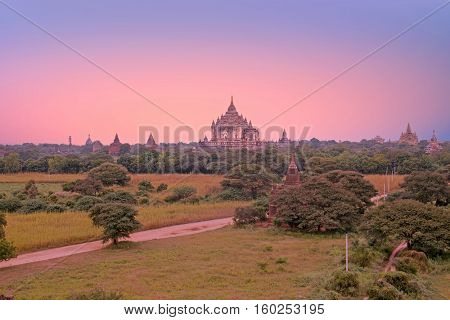 Ancient pagodas in the landscape from Bagan in Myanmar at sunrise
In the middle the Dhammayangyi Temple, The biggest of all temple in Bagan. 