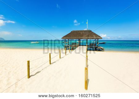 Sandy tropical Wolmar beach at sunny day. Jetty on the foreground.  Mauritius