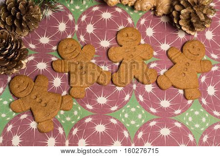 Christmas smiling gingerbread men men and women on background with Christmas decoration