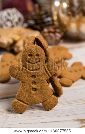 Christmas smiling gingerbread men men and women on rustic wooden background