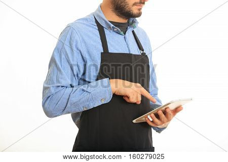 Young Man With Black Apron Taking An Order