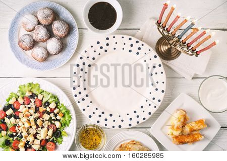 Traditional Hanukkah dishes on the white wooden table horizontal