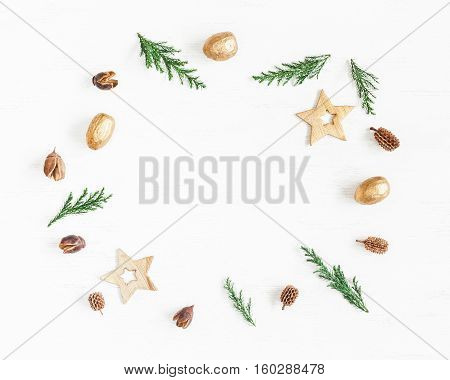 Christmas composition. Frame made of christmas decoration cypress branches pine cones. Flat lay top view