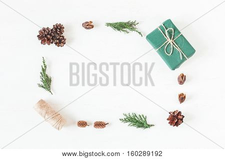Christmas composition with pine cones cypress branches christmas gift. Top view flat lay