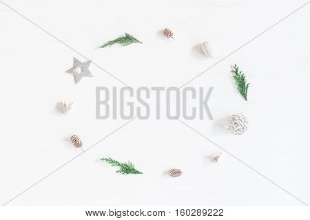 Christmas composition. Frame made of christmas decoration cypress branches pine cones. Flat lay top view